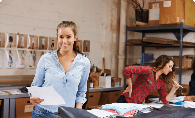 Student with a piece of paper in textile workshop